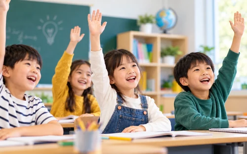 Children raising their hands in a classroom